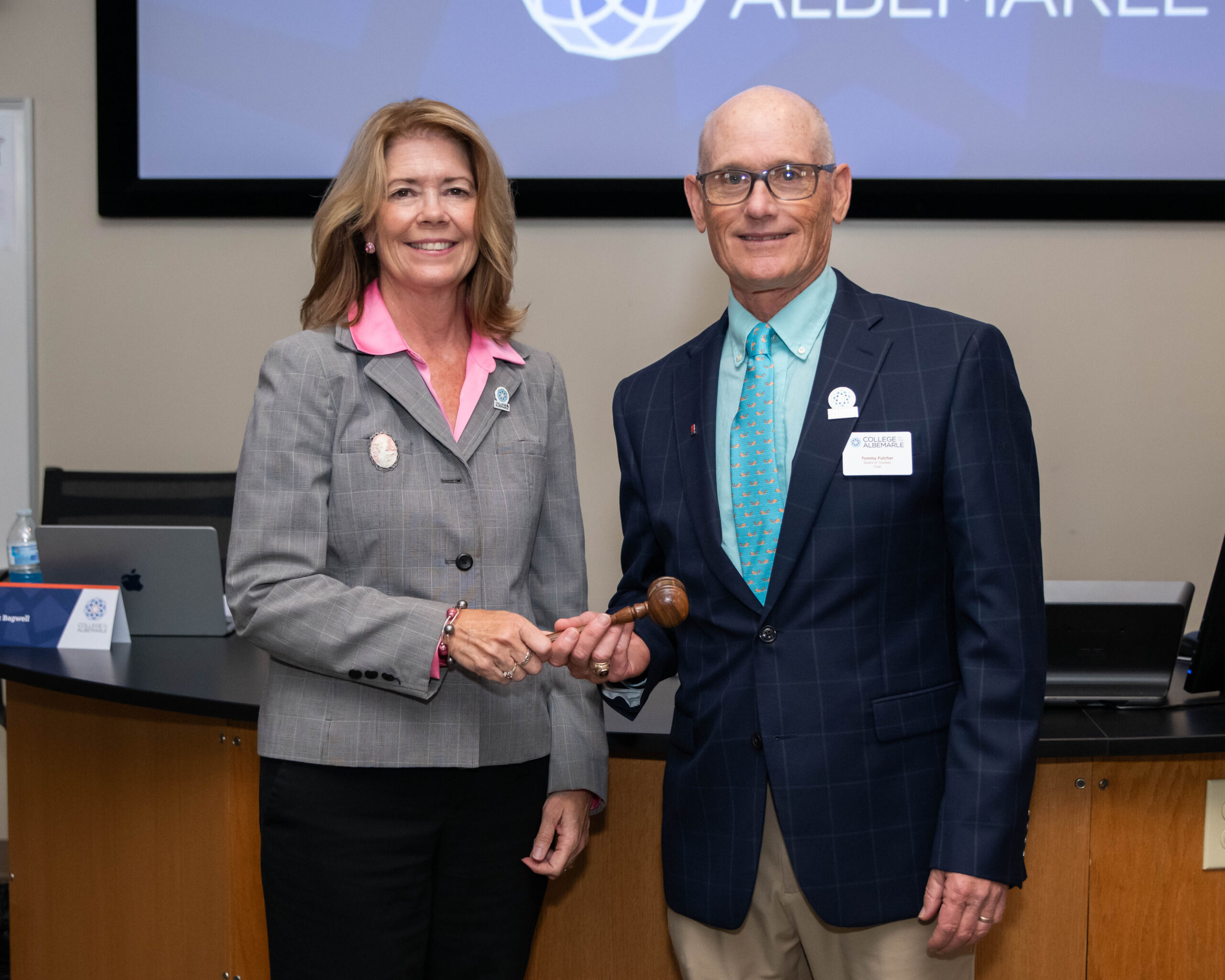 Tommy Fulcher (left), immediate past COA Board of Trustees Chair, presents the gavel to Selina Jarvis (right), newly named chair.