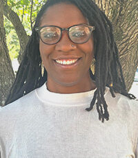 Jessica Buckley-Williams pictured smiling outside in front of a tree.